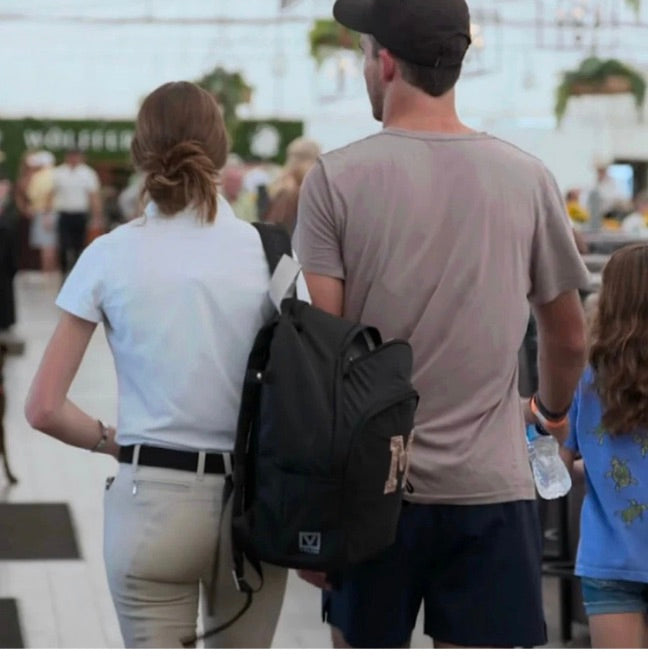 People walking in a polo-themed scene, carrying the Veltri Sport Grande Backpack, showcasing its structured design and versatile, performance-ready style in a lifestyle sports setting.