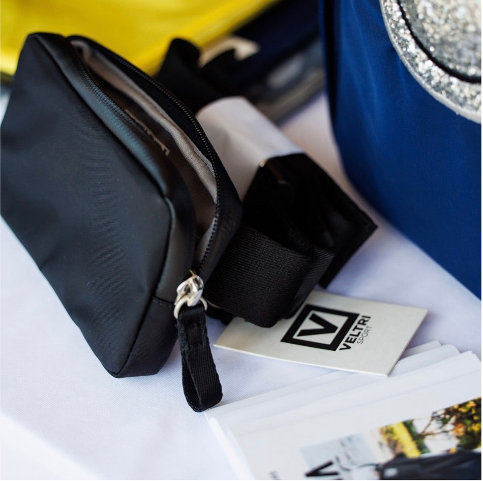 Veltri Sport Large Eaton Belt Bag presented on table with other products.