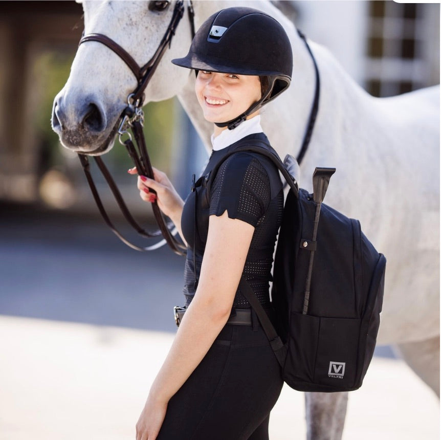 Equestrian girl and her horse with her Veltri Sport Delaire backpack in black on.