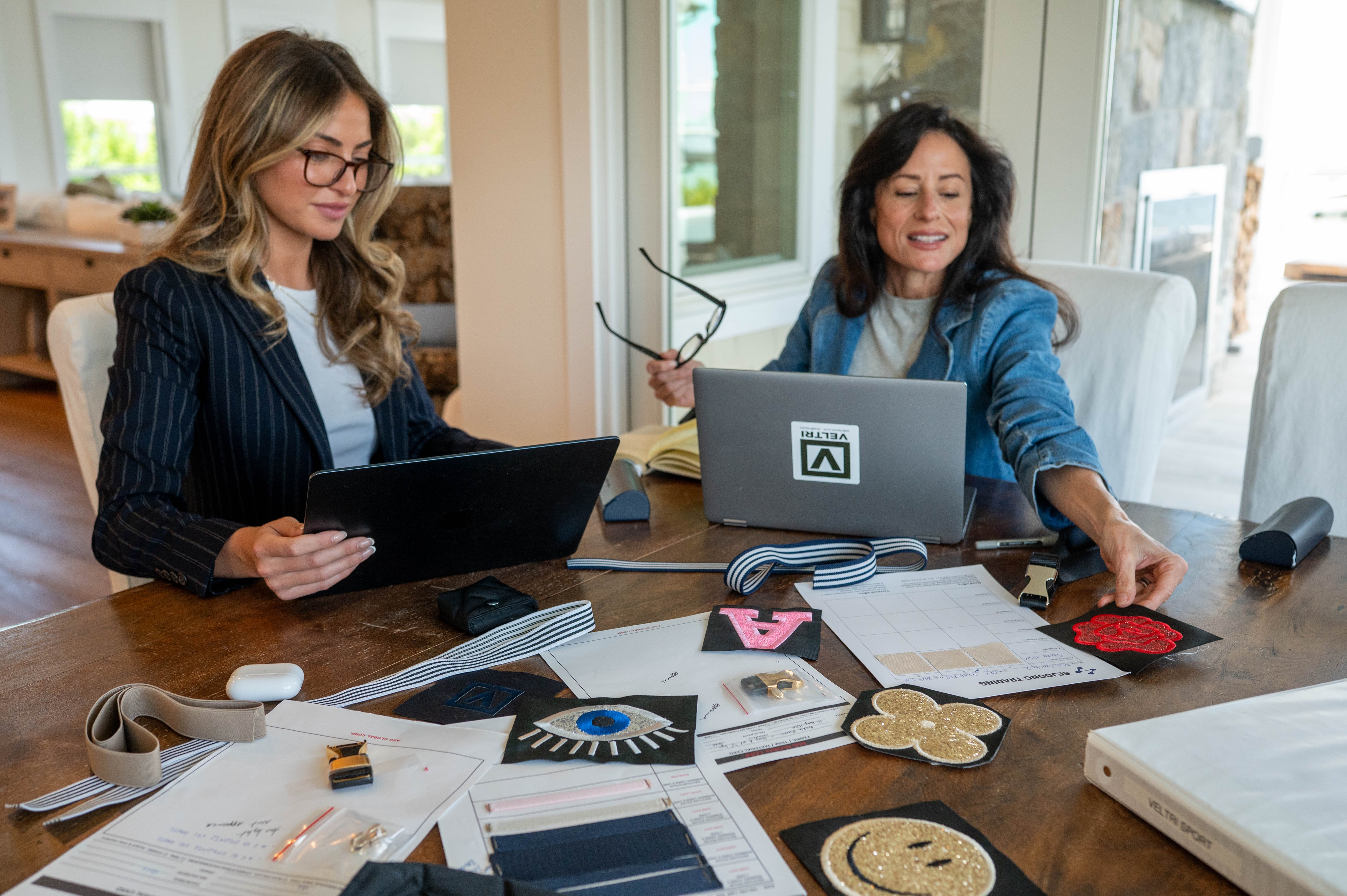 Lisa and Alessandra Veltri at their work table communicating about new design ideas