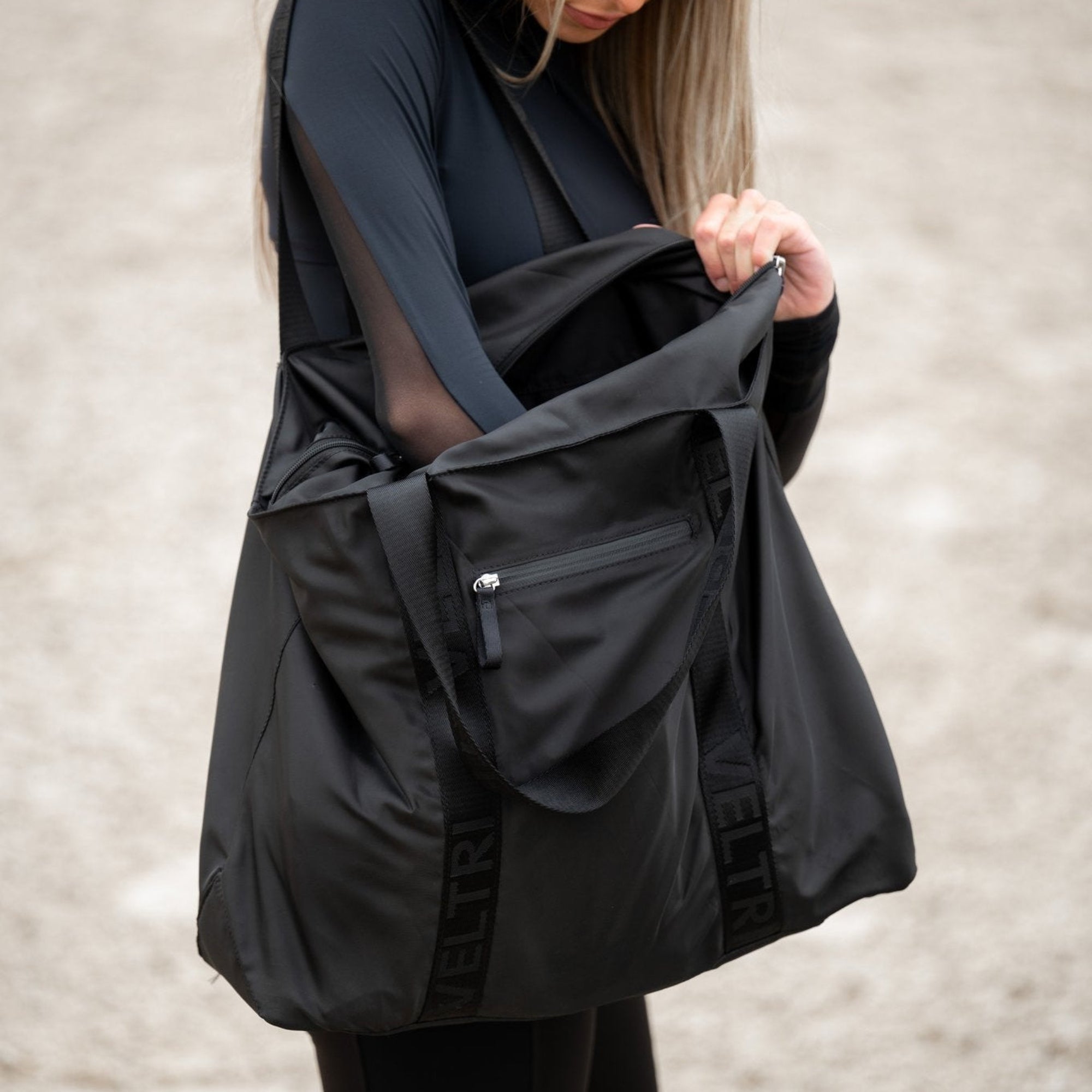 Veltri Sport Newport Tote in black shown open, highlighting organized interior and zip closure for everyday use